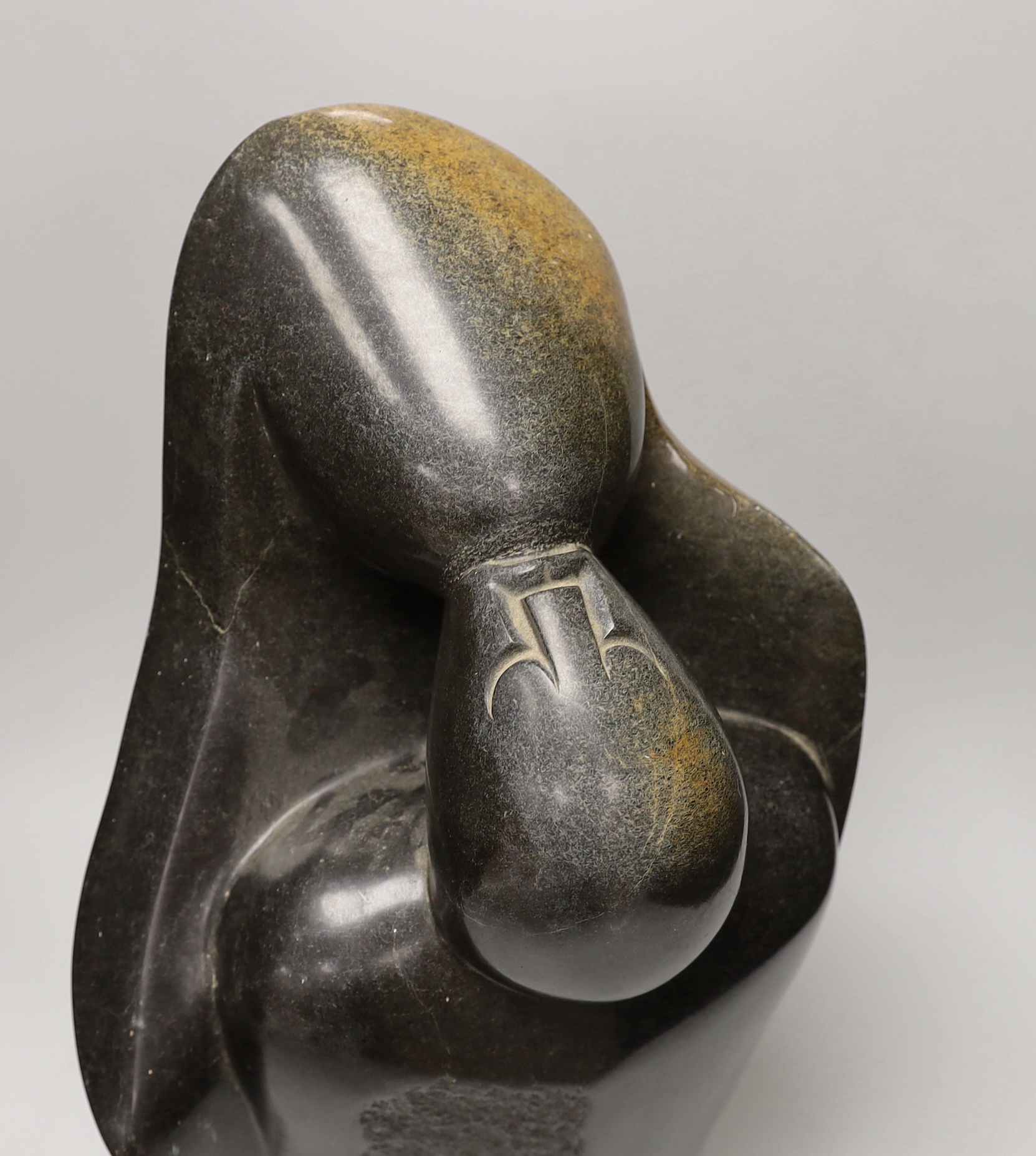 A Zimbabwe soapstone carving of two embracing figures, signed B Nehlimba, 53cm high